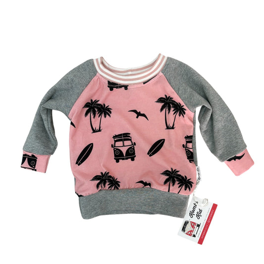 Pink and gray sweatshirt with palm tree and car design on a white background