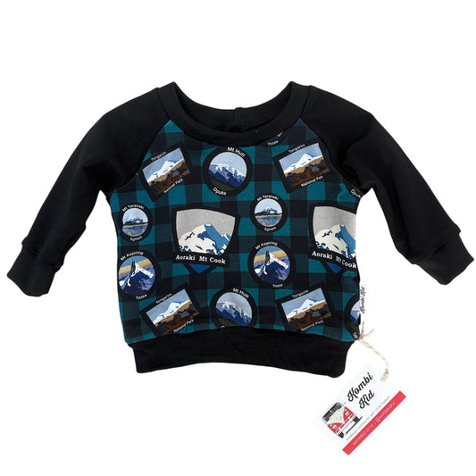 Black sweatshirt with mountain graphic design on a white background
