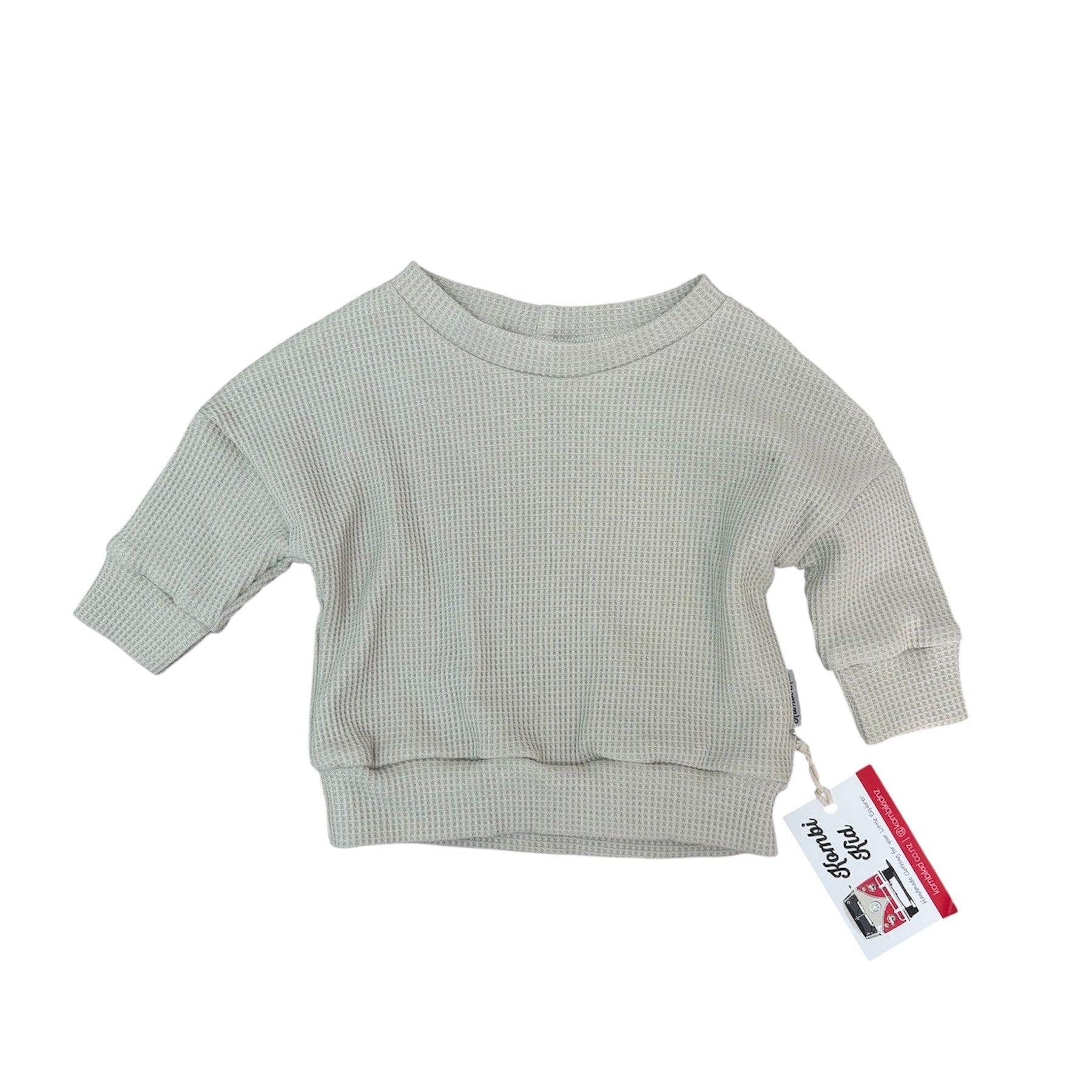 Light gray ribbed sweater with a tag on a white background